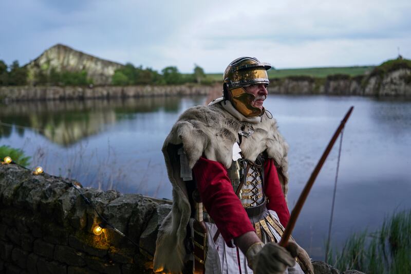 A Roman archer waits to fire flaming arrows into a floating beacon on the lake during Queen Elizabeth II’s platinum jubilee beacon lighting ceremony at Cawfield Quarry on Hadrian’s Wall on June 02, 2022 in Haltwhistle, England. Getty