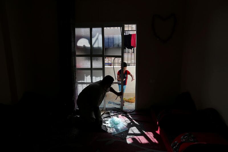 A Palestinian man inspects his damaged house after an Israeli air strike on a nearby Hamas site, in Khan Younis in the southern Gaza Strip. Reuters