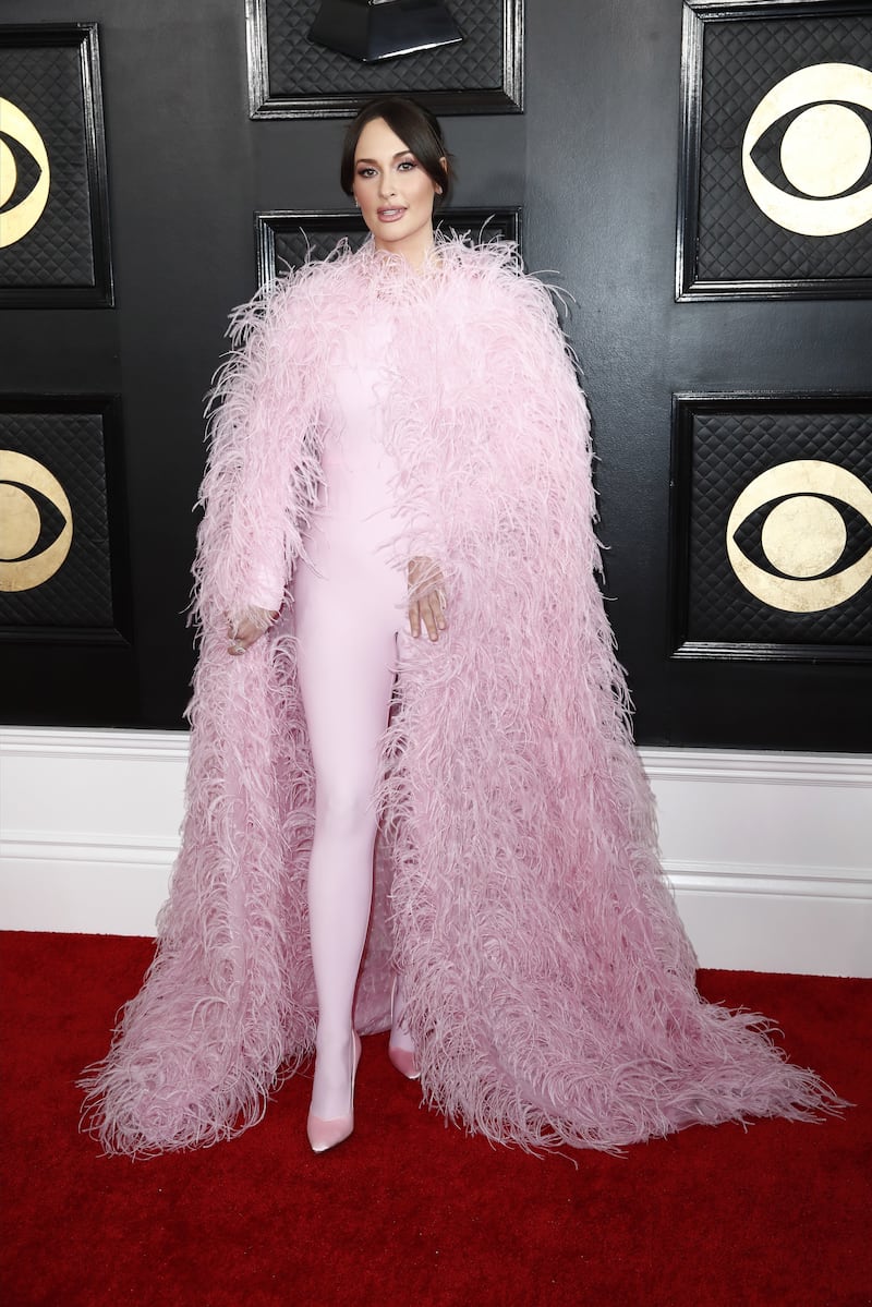 Kacey Musgraves wears a powder pink bodysuit and feathered cape by Valentino. EPA 