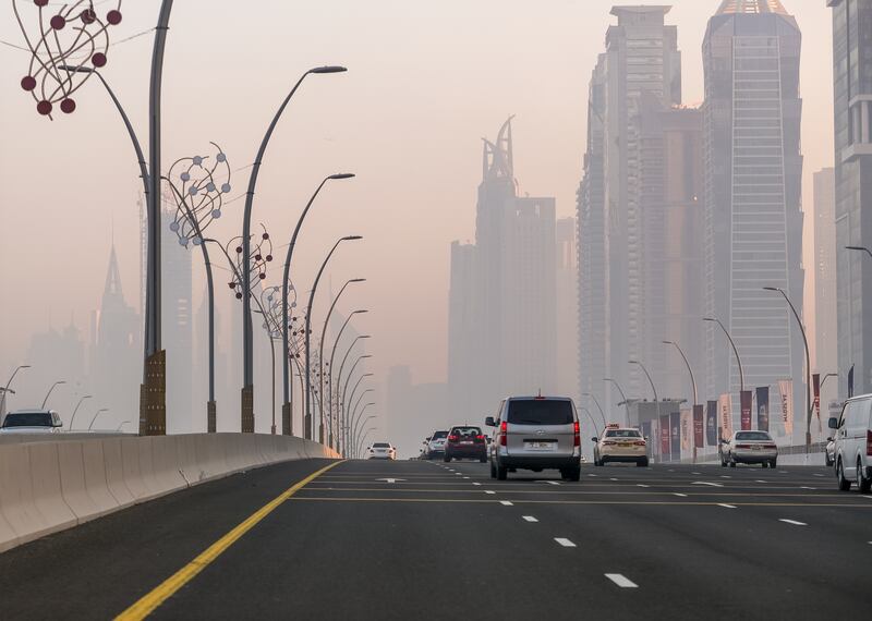 Dubai's tall buildings pierce the fog. Victor Besa / The National