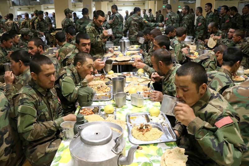 Iftar for soldiers of the Afghan National Army as they break their fast at their base in Herat, western Afghanistan. Muslims celebrate Ramadan with prayer and by abstaining from eating and drinking between sunrise and sunset. EPA