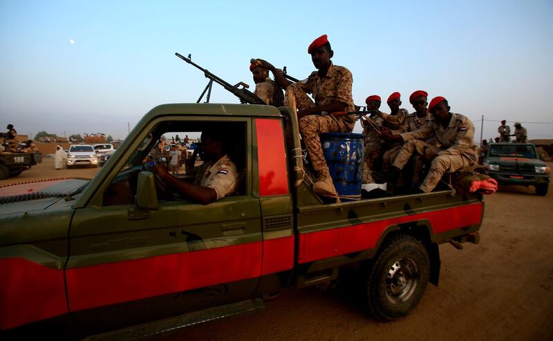 A technical (pickup truck mounted with a machine gun turret) carrying members of Sudan's Rapid Support Forces (RSF) paramilitaries drives by during a rally in the village of Qarri, about 90 kilometres north of Khartoum.  AFP