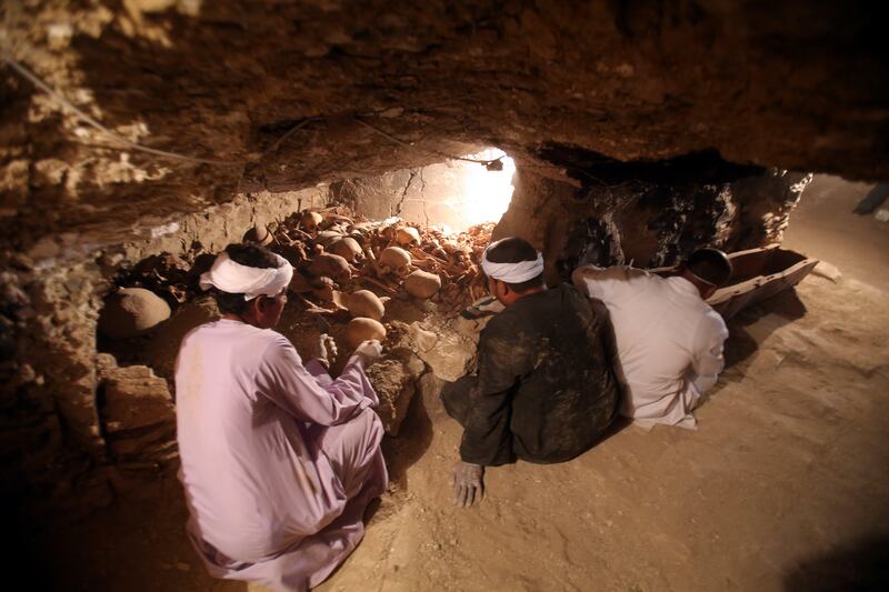 Egyptian archaeologists work inside a recently discovered tomb at the Draa Abul Nagaa necropolis in Luxor's West Bank in Egypt. Khaled Elfiqi / EPA