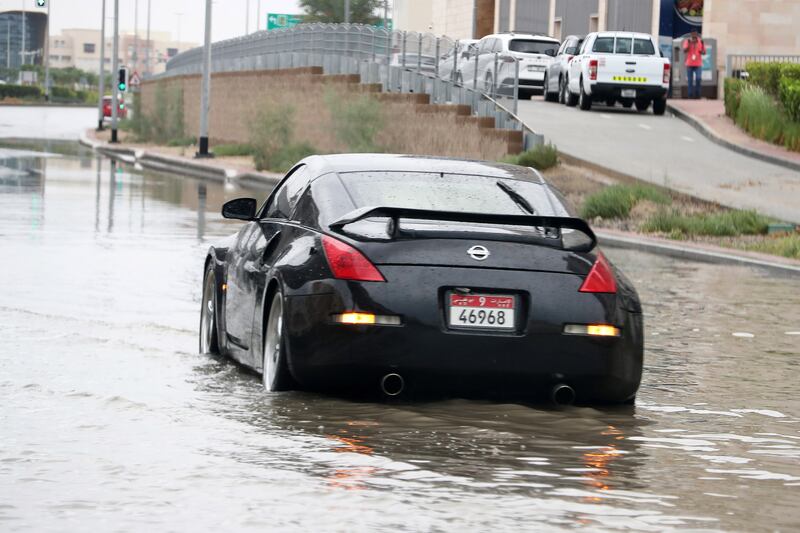 A car struggles through the water in Dubai. Pawan Singh / The National