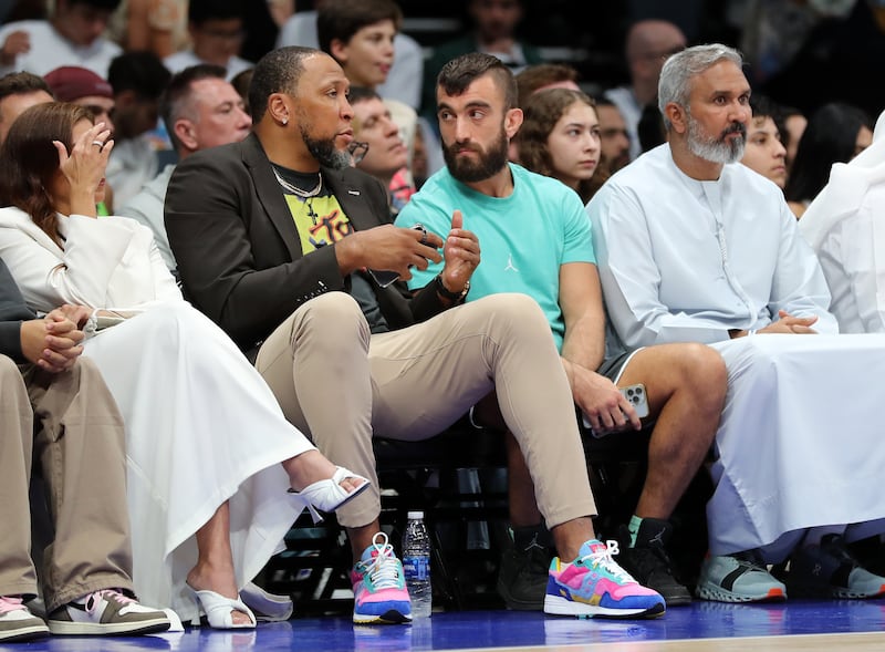 Emirati UFC fighter Mohammed Yahya speaks to former Dallas Mavericks forward Shawn Marion (L) during the game between the Minnesota Timberwolves and Dallas Mavericks in a pre-season NBA game as part of the Abu Dhabi Games 2023. Etihad Arena, Abu Dhabi. Chris Whiteoak / The National