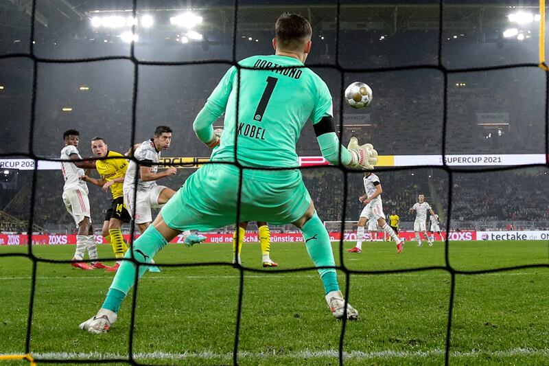 Dortmund goalkeeper Gregor Kobel cannot stop Robert Lewandowski opening the scoring.