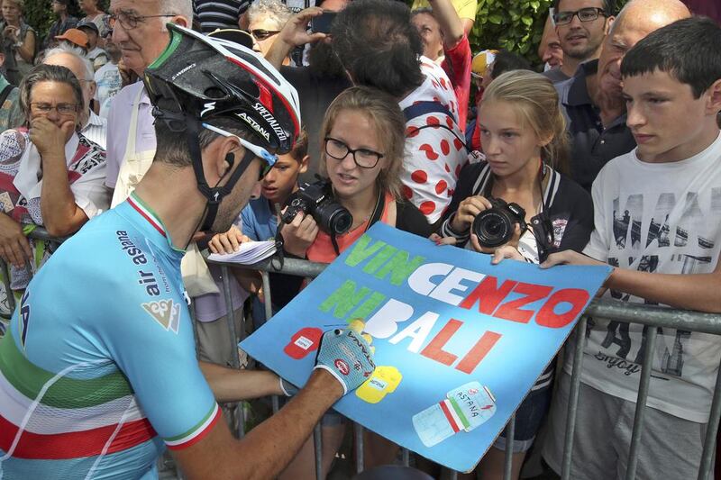 Vincenzo Nibali, otherwise known as the Shark of Messina, signs an autograph for young cycling fans on Monday. Stefano Rellandini / Reuters

