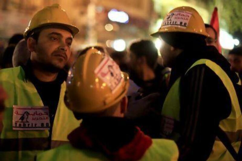 Egyptian volunteers of Tahrir Bodyguard, an anti-harassment group, work at a rally in Tahrir Square, Cairo.