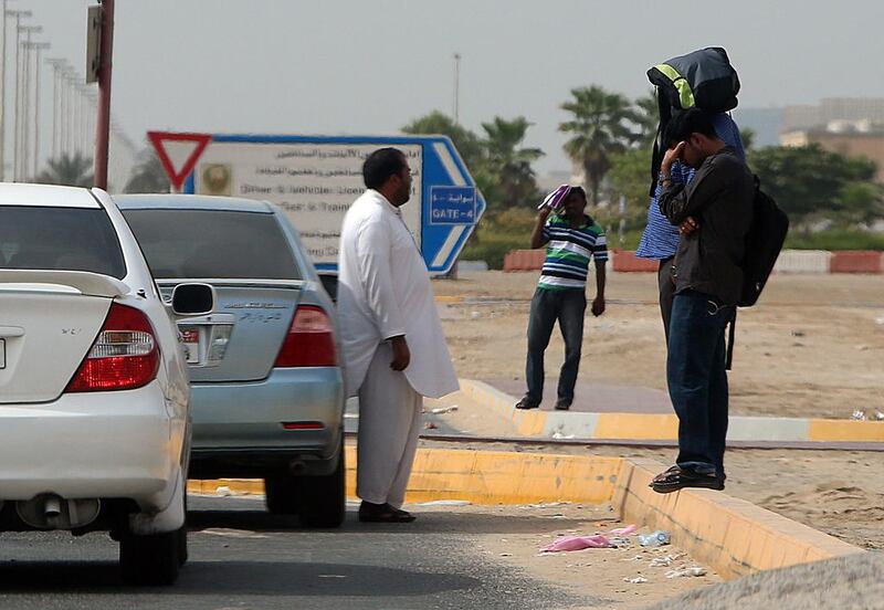 An illegal cab driver waits for customers outside the Emirates Driving Company in Mussaffah, Abu Dhabi. Satish Kumar / The National