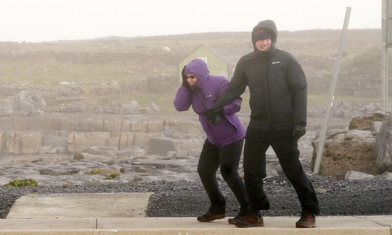 People brave high winds in Doolin, County Clare, on the west coast of Ireland. PA