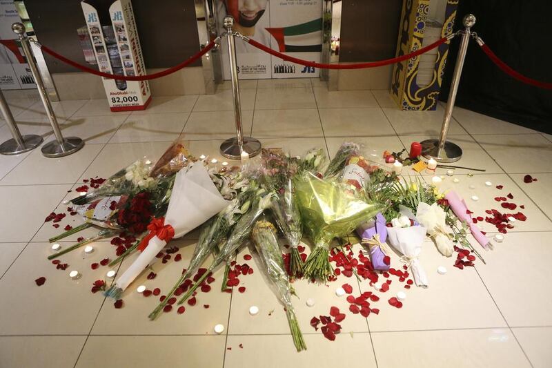 People lay flowers and lit candles near to where Ibolya Ryan was killed in the ladies toilets. Sarah Dea / The National