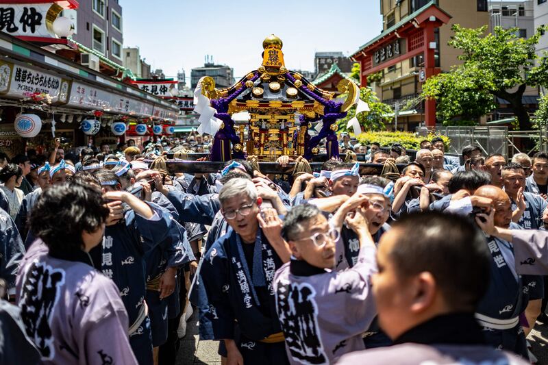 Participants carry a portable shrine on the second day of the annual Sanja Matsuri festival, in the Asakusa district of Tokyo. AFP