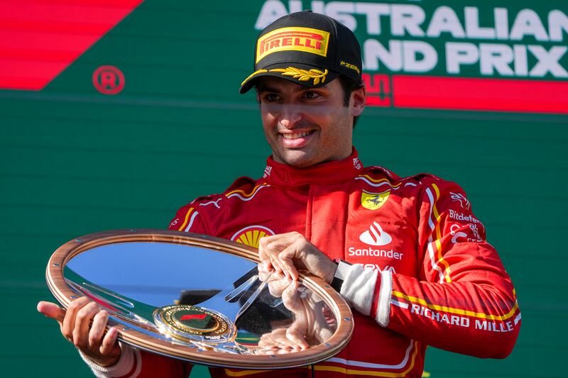 Ferrari driver Carlos Sainz of Spain celebrates on the podium after winning the Australian Formula One Grand Prix at Albert Park, in Melbourne, Australia, Sunday, March 24, 2024.  (AP Photo / Asanka Brendon Ratnayake)