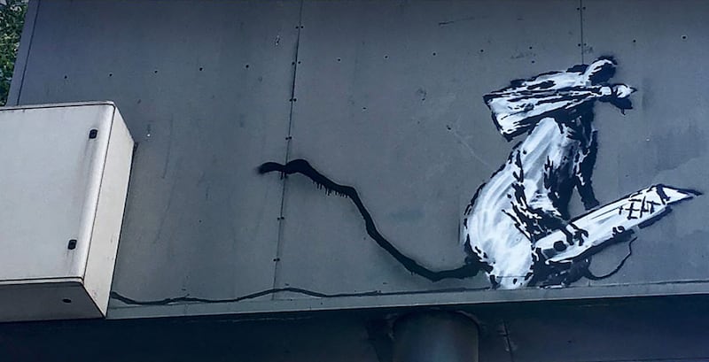 An image from the Pompidou Centre taken in September 2019 shows the depiction of a masked rat by British street artist Banksy on the back of a parking sign in Paris. AFP