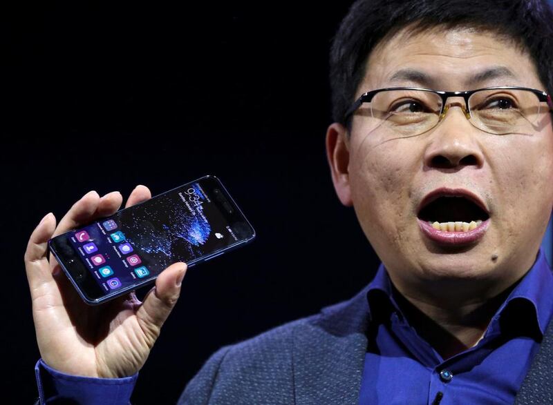 Richard Yu, chief executive of Huawei’s consumer business, holds up the new P10 device during a presentation ceremony. Paul Hanna / Reuters