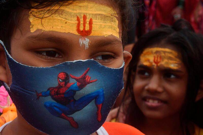 A young Hindu devotee starts his journey to the Shiva Temple after taking holy dip and performing rituals at the banks of the holy river Ganges, in Kolkata amid the coronavirus pandemic, which has so far claimed 50,000 lives in the country. AFP