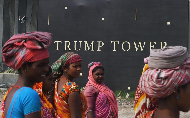 Indian labourers prepare to collect bricks as they work on building the road leading to the under-construction Trump Tower in Kolkata. Dibyangshu Sarkar / AFP