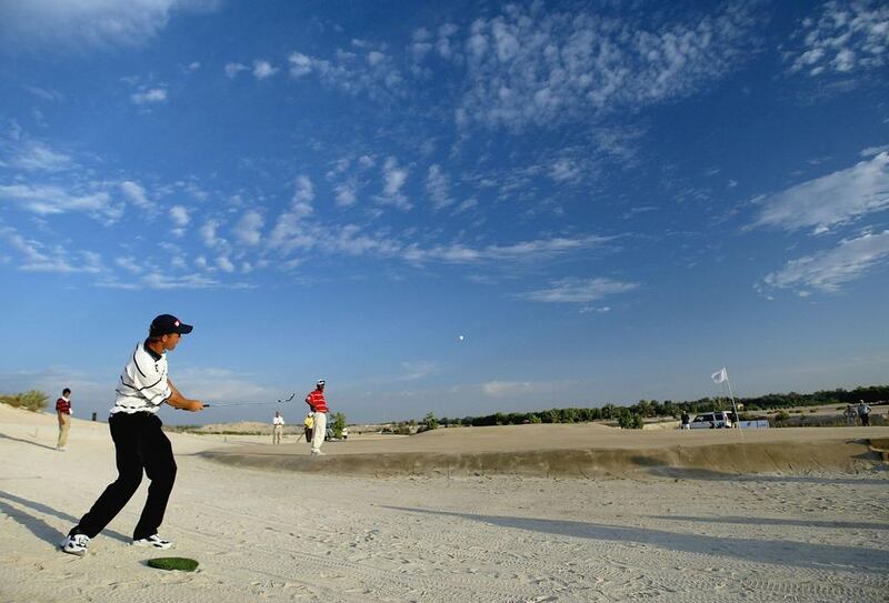 Padraig Harrington of Ireland plays his third shot to the par-five 17th hole at the Abu Dhabi World Sand Golf Championship at the Al Ghazal Golf Club, in 2004. Ross Kinnaird / Getty Images