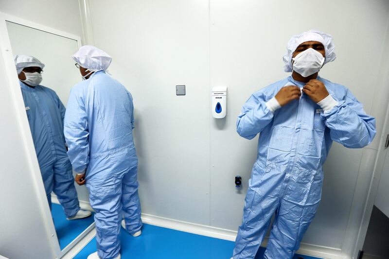 RAK , UNITED ARAB EMIRATES : July 8 , 2013 - Workers changing the dress before entering into the Final Purification of Insulin area in the J 11 unit at Gulf Pharmaceutical Industries in Ras Al Khaimah. In this J 11 unit they are making Insulin. ( Pawan Singh / The National ) . For Business.