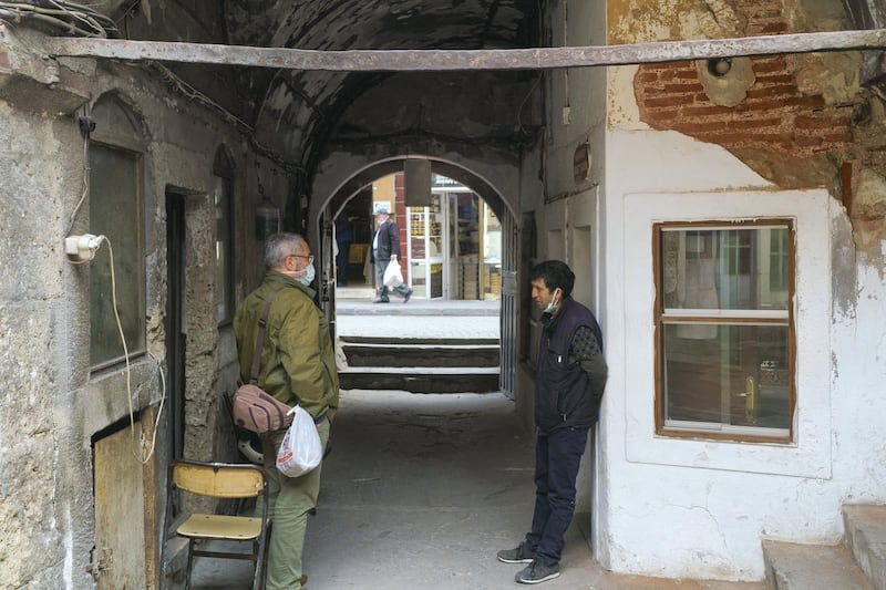 Ozturk,49 talking to his friend. 18th century building.“Corlulu Ali Pasha” inn-yard in the Küçükpazar district in Istanbul.

The courtyard is entered by passing through the arched door and passage on the street of Kucukpazar, Istanbul. Mehmet, 49, has a family owned tea shop here for 58 years. Istanbul, Turkey 2021