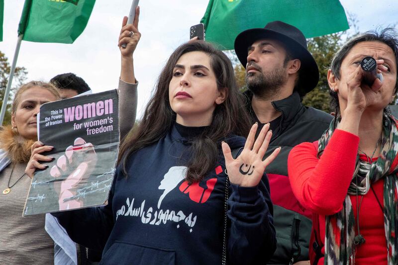 A protester wearing a top with a logo that reads 'No to an Islamic state" as she takes part in a rally in support of the Iranian people, in Brussels. AFP