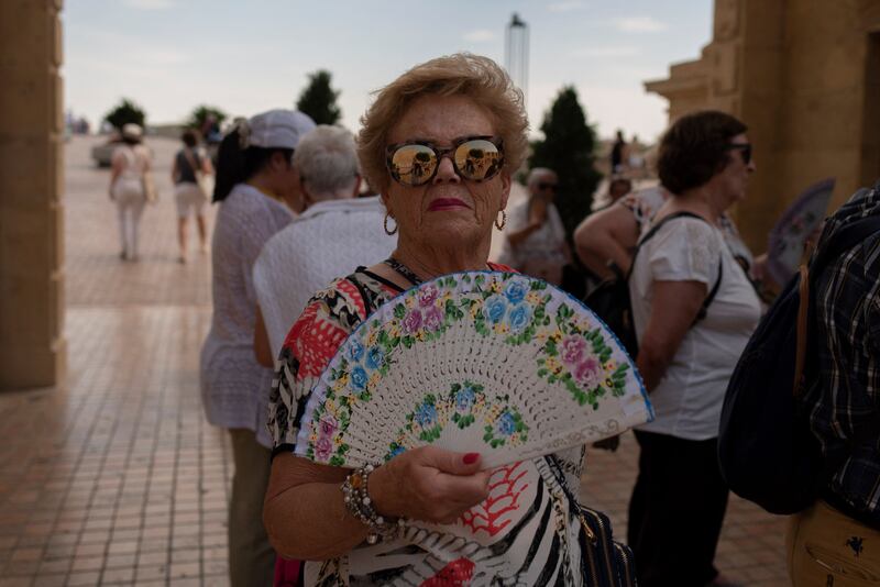 A woman cools off with a fan amid the heat in Cordoba, Spain. AFP