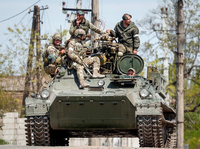 Russian service members atop an armoured vehicle in Mariupol. Reuters