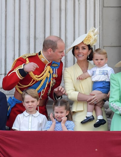 (L-R) Britain's Prince William, Duke of Cambridge, Prince George, Princess Charlotte and Britain's Catherine, Duchess of Cambridge holding Prince Louis stand with other members of the Royal Family on the balcony of Buckingham Palace to watch a fly-past of aircraft by the Royal Air Force, in London on June 8, 2019.

 The ceremony of Trooping the Colour is believed to have first been performed during the reign of King Charles II. Since 1748, the Trooping of the Colour has marked the official birthday of the British Sovereign. Over 1400 parading soldiers, almost 300 horses and 400 musicians take part in the event. / AFP / Daniel LEAL-OLIVAS
