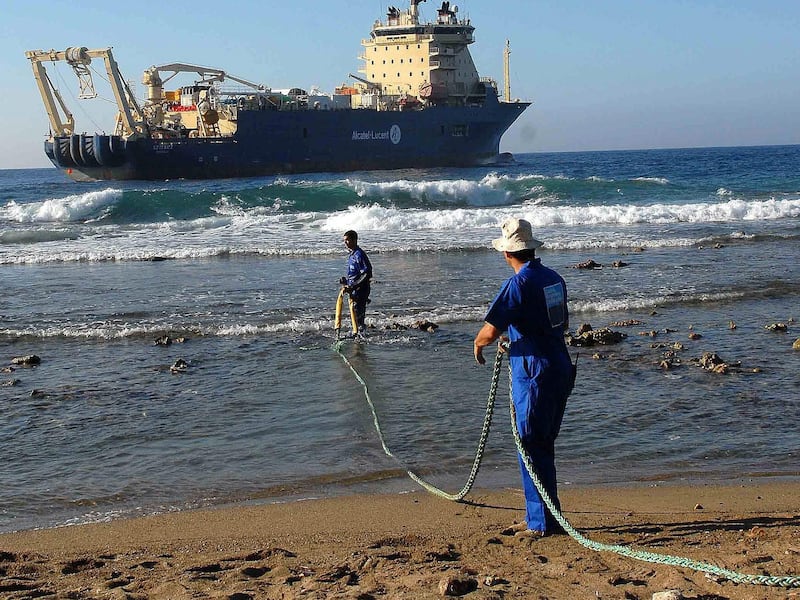 Workers pay out an undersea fibre-optic cable from the coast of Cuba. EPA