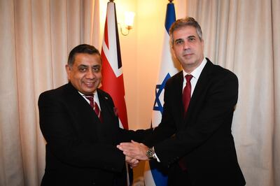 Israeli Foreign Minister Eli Cohen shakes hands with Lord Ahmad of Wimbledon during a meeting at the Israeli embassy in London. Photo: Eli Cohen / Twitter