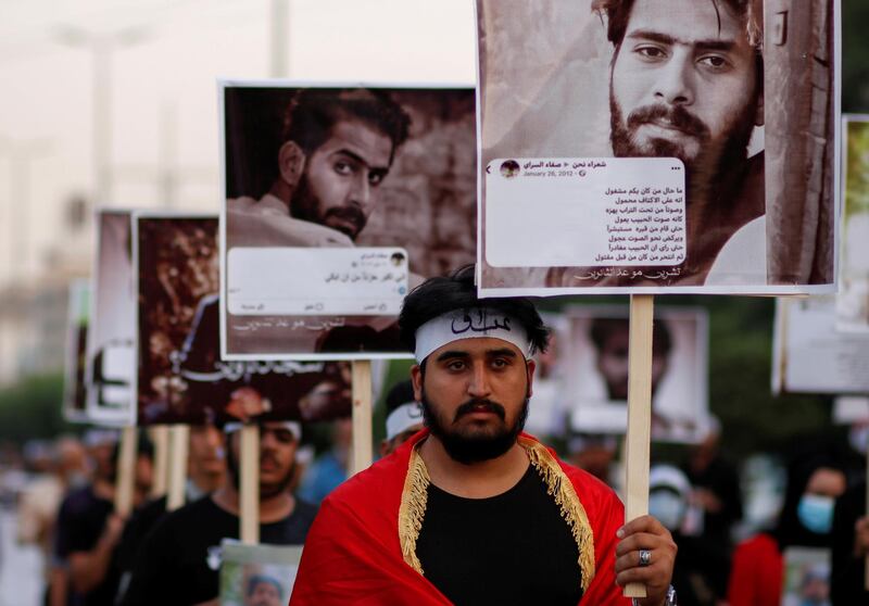 Iraqi demonstrators carry pictures of demonstrators who were killed during anti-government protests, in Baghdad, Iraq October 28, 2020. REUTERS/Saba Kareem     TPX IMAGES OF THE DAY