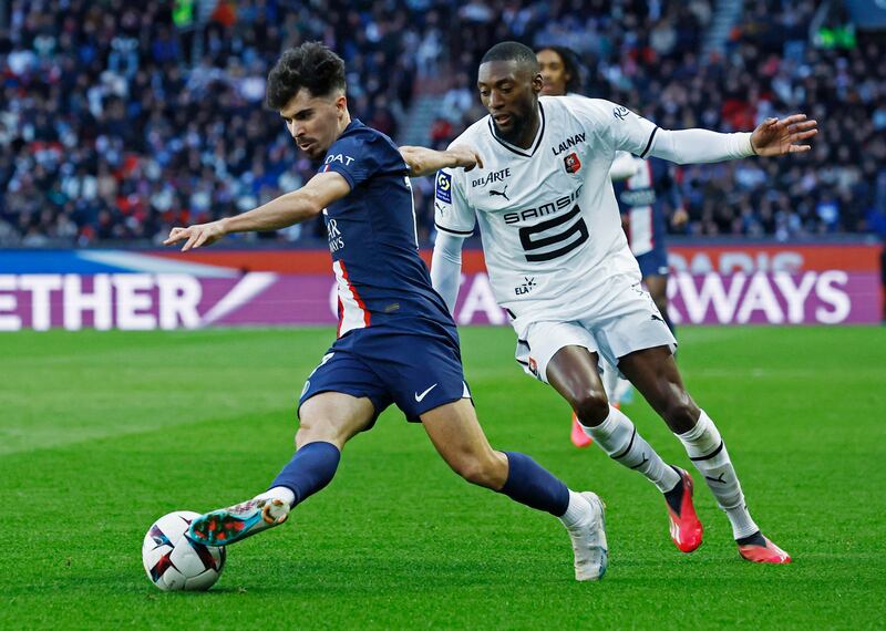 PSG's Vitinha in action with Stade Rennes' Karl Toko-Ekambi. Reuters