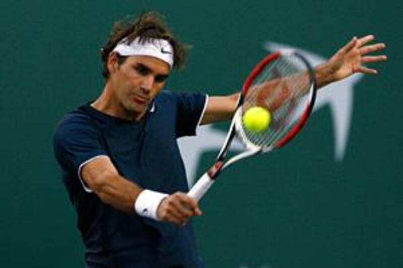 The world No 2 Roger Federer returns a backhand to Marc Gicquel on his way to a 7-6, 6-4 victory in their second round match at Indian Wells.