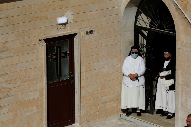 Nuns stand outside the Chaldean Catholic Church. Reuters