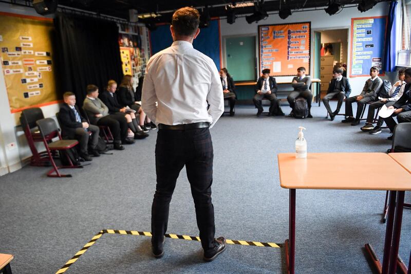 Drama teacher Geoff Nolan gives a socially distanced class to pupils at Holyrood Secondary School in Glasgow for the first time following the easing of coronavirus lockdown measures on August 12, 2020. - It will be the first time since March that Scottish pupils will have attended schools. (Photo by Andy Buchanan / AFP)