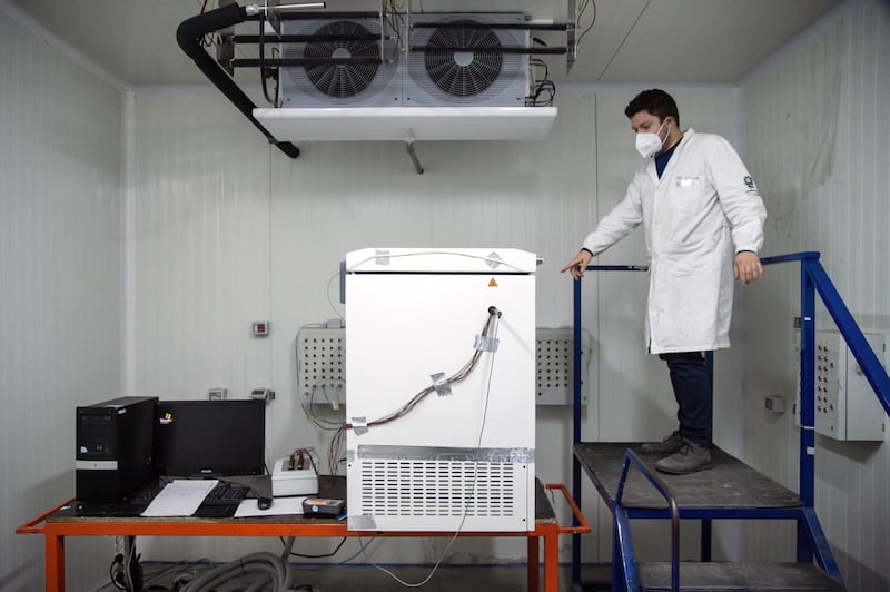 An engineer inspects the refrigerator prototype designed by Desmon s.p.a. to store Covid-19 vaccines in Nusco, Italy. Getty Images