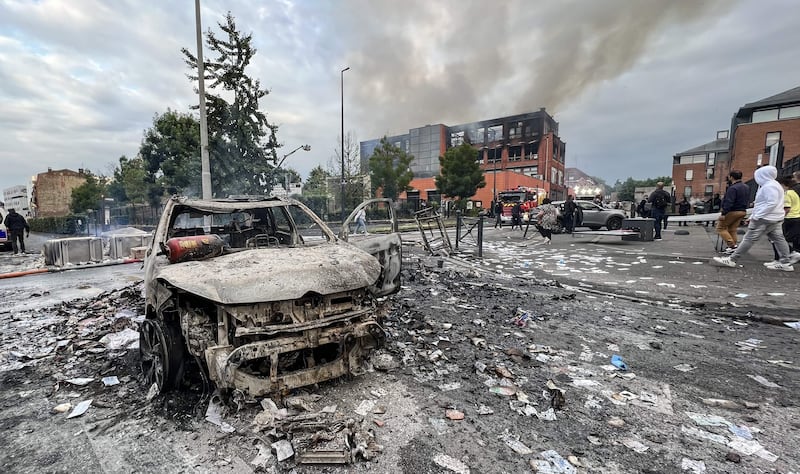 A burnt out car and office building in Alma district of Roubaix, northern France, amid protests after police fatally shot a teenager in the Paris suburbs. AFP