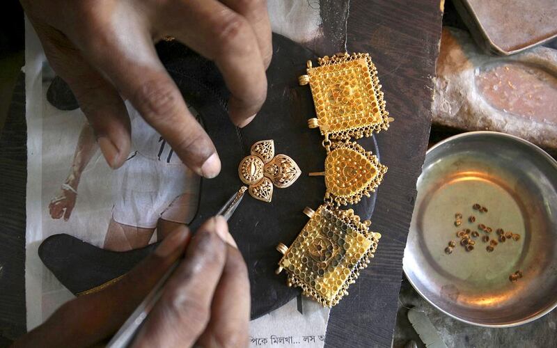 An Indian goldsmith makes jewellery in Gauhati, India. Anupam Nath / AP Photo