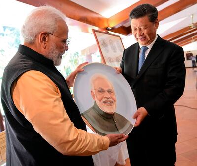 In this handout photograph taken and released by the India's Press Information Bureau (PIB) on October 12, 2019, India's Prime Minister Narendra Modi (L) exchanges gifts with China's President Xi Jinping in Mahabalipuram in Tamil Nadu state. India's Prime Minister Narendra Modi said on October 12 that his summit with Chinese leader Xi Xinping would launch a "new era" between the neighbours who are seeking to overcome troublesome differences. - RESTRICTED TO EDITORIAL USE - MANDATORY CREDIT "AFP PHOTO / PIB" - NO MARKETING NO ADVERTISING CAMPAIGNS - DISTRIBUTED AS A SERVICE TO CLIENTS -
 / AFP / PIB / Handout / RESTRICTED TO EDITORIAL USE - MANDATORY CREDIT "AFP PHOTO / PIB" - NO MARKETING NO ADVERTISING CAMPAIGNS - DISTRIBUTED AS A SERVICE TO CLIENTS -
