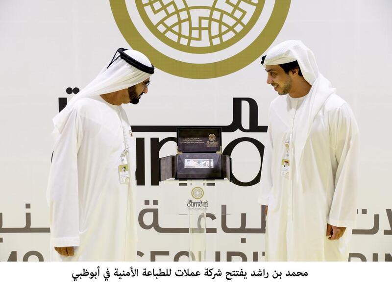 Sheikh Mohammed bin Rashid, Vice President and Ruler of Dubai, receives the first Dh1,000 note printed by the company, which bears the number 1, from Sheikh Mansour bin Zayed, Deputy Prime Minister and Minister of Presidential Affairs. Wam