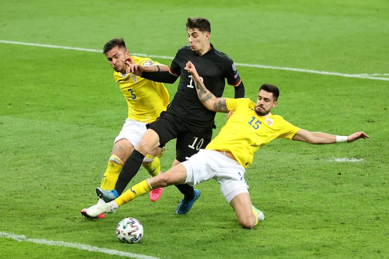 Kai Havertz of Germany is challenged by Alin Tosca and Andrei Burca of Romania. Getty
