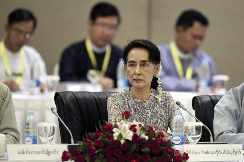 Myanmar's Aung San Suu Kyi (C) looks on at a meeting in Naypyitaw. Ms Suu Kyi is leading a delegation to China EPA/HEIN HTET