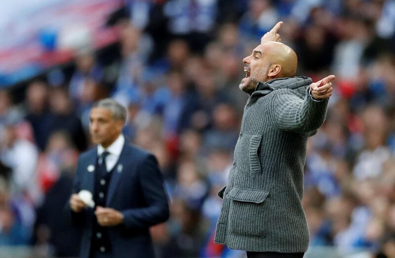 Manchester City manager Pep Guardiola reacts as Brighton manager Chris Hughton looks on. Reuters