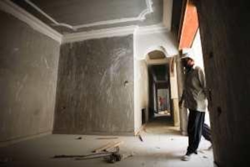 A Construction worker walks inside a building that he works in and which will be sold in apartments in east Amman, Jordan on May 09, 2010. (Salah Malkawi for The National)