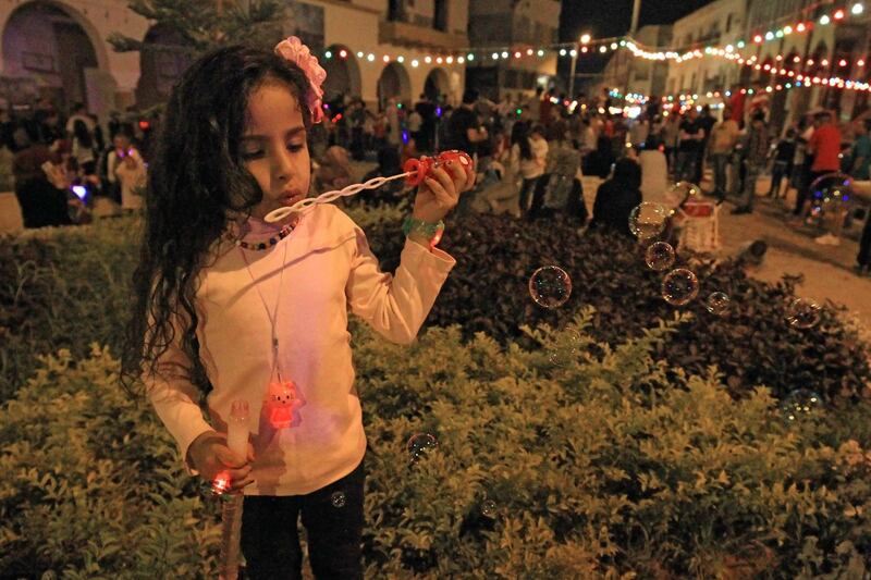 A girl blows bubbles as Muslims celebrate the birthday of Prophet Mohammed, known as "al-Mawlid al-Nabawi", in Libya's eastern city of Benghazi. AFP