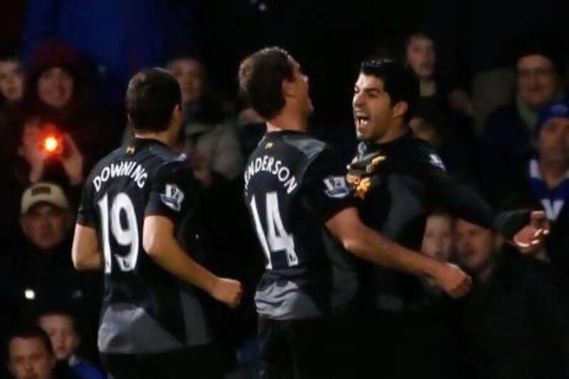 Liverpool's Luis Suarez, right celebrates scoring against Queens Park Rangers.