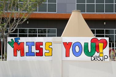 DUBAI, UNITED ARAB EMIRATES , August 9 – 2020 :- ‘We Miss You’ message on the boundary wall of the Dubai British School in Jumeirah Park in Dubai. New Covid safety setup in different areas of the school such as hand sanitizer, safety message, social distancing stickers pasted on the floor, thermal cameras will be installed at the entrance of the school. School will open on 30th August. (Pawan Singh / The National) For News/Online/Instagram. Story by Kelly