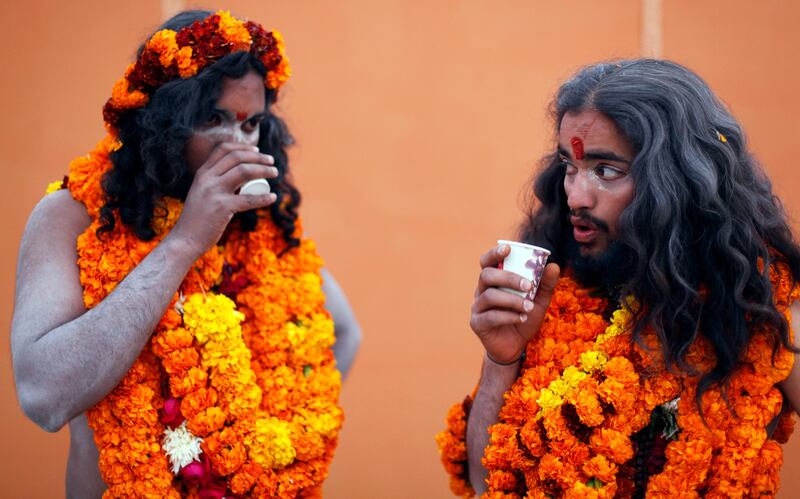 Naga Sadhus, or naked Hindu holy men of the Panchayati Akhada Sri Niranjani group, drink tea after a religious procession towards Sangam, the confluence of rivers Ganges, Yamuna and mythical Saraswati, as part of the Mahakumbh festival in Allahabad, India, Friday, Jan. 4, 2013. Millions of Hindu pilgrims are expected to take part in the large religious congregation on the banks of Sangam during the Mahakumbh festival in January 2013, which falls every 12th year. (AP Photo/Rajesh Kumar Singh) *** Local Caption ***  India Kumbh Festival.JPEG-077e2.jpg