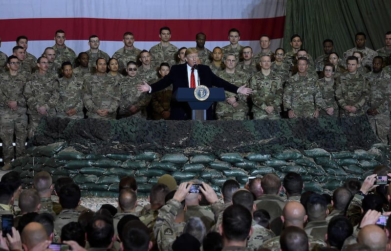 (FILES) In this file photo taken on November 28, 2019 US President Donald Trump speaks to the troops during a surprise Thanksgiving day visit at Bagram Air Field, in Afghanistan. President Donald Trump has shattered norms and niceties on the world stage in his nearly three years in office. Entering an election year, Trump is unlikely to slow down as he seeks what has largely eluded him -- a headline-grabbing victory. / AFP / Olivier Douliery
