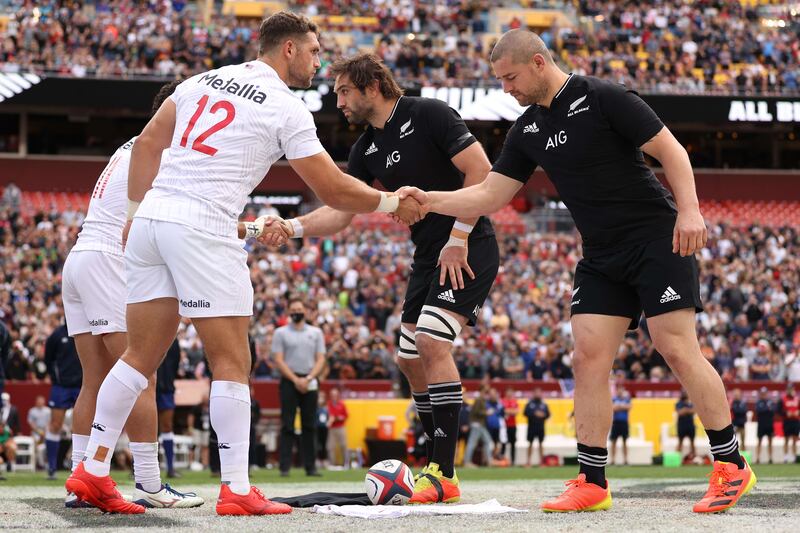 New Zealand All Blacks and the USA Eagles shake hands and exchange jerseys before playing at FedExField. AFP